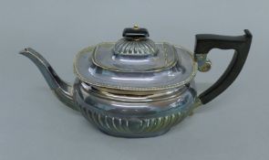A silver teapot. 29 cm long. 23.2 troy ounces total weight.