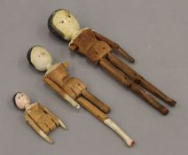 Three antique wooden peg dolls. The largest 28.5 cm high.