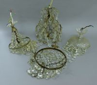 Four various glass chandeliers. The largest 34 cm high.