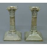 A pair of Corinthian column silver candlesticks. 15 cm high.