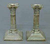 A pair of Corinthian column silver candlesticks. 15 cm high.