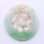 A jade roundel. 5.5 cm diameter.