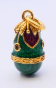 A silver and malachite egg pendant. 2 cm high.