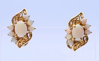 A pair of 14 ct gold and opal earrings. 2 cm high. 6.9 grammes total weight.
