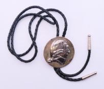 A silver-mounted bolo tie set with the bust of George Washington. 5 cm diameter.