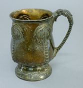 A Victorian silver mug decorated with palm trees. 1.5 cm high. 6.7 troy ounces.