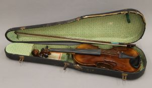 A cased violin and bow. The violin 59 cm long.