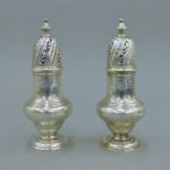 A pair of George II silver castors, hallmarked for London 1744, maker's mark of SW. 16 cm high. 464.