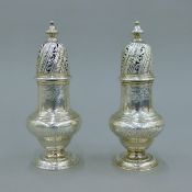 A pair of George II silver castors, hallmarked for London 1744, maker's mark of SW. 16 cm high. 464.
