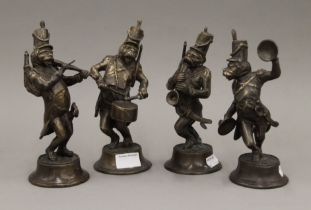 Four brass monkey band figures. Each approximately 22 cm high.