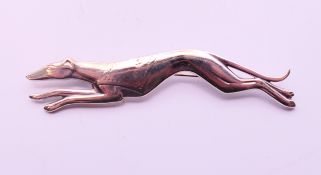 A silver greyhound brooch. 7 cm wide.