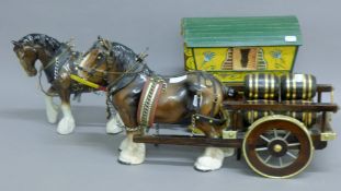 Two porcelain cart horses with a cart and gypsy caravan. The caravan 27 cm high.