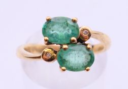 A 9 ct gold diamond and emerald ring. Ring size M.