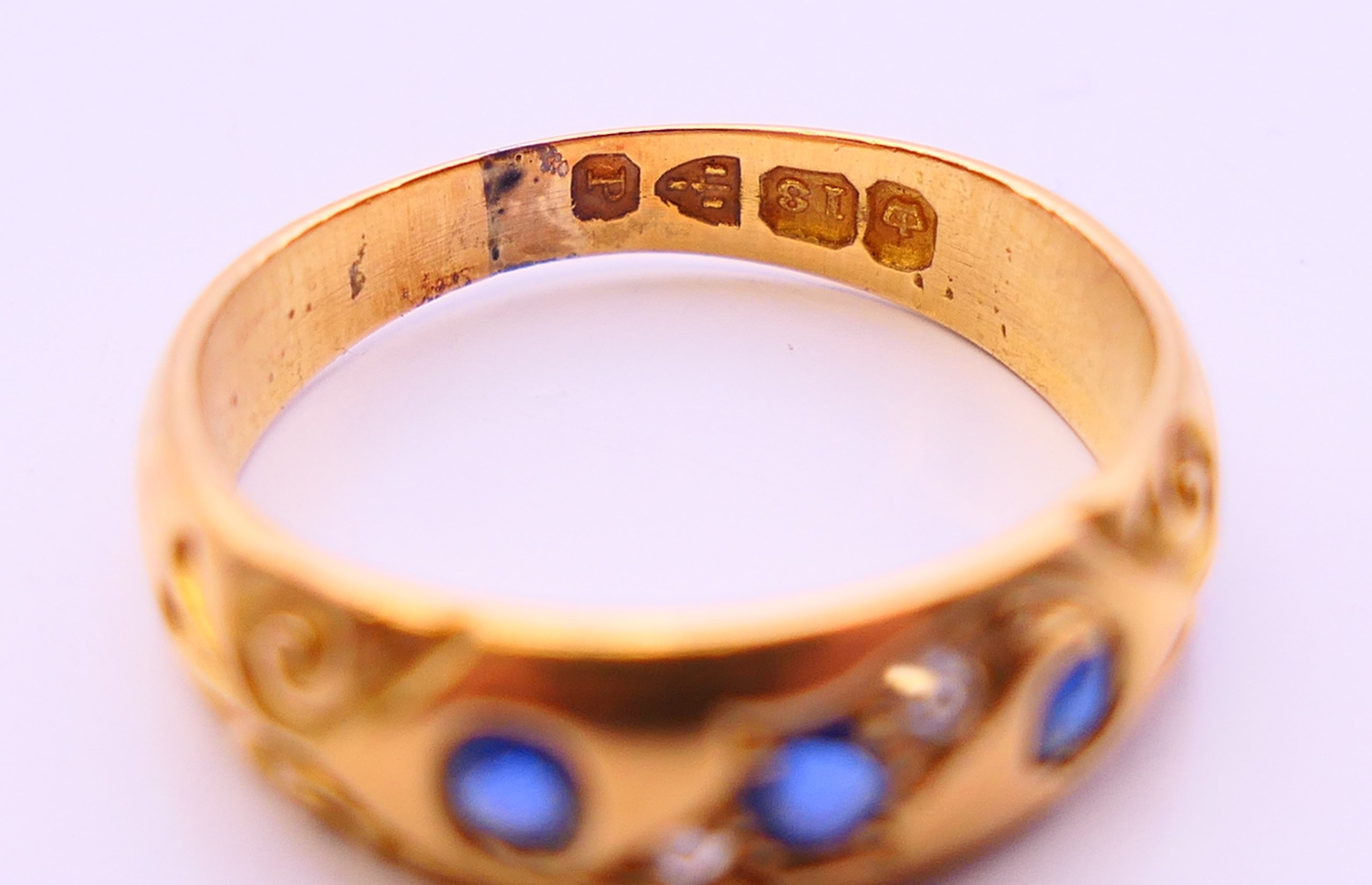 An 18 ct gold diamond and sapphire ring. 4 grammes. Ring size L/M. - Image 4 of 5