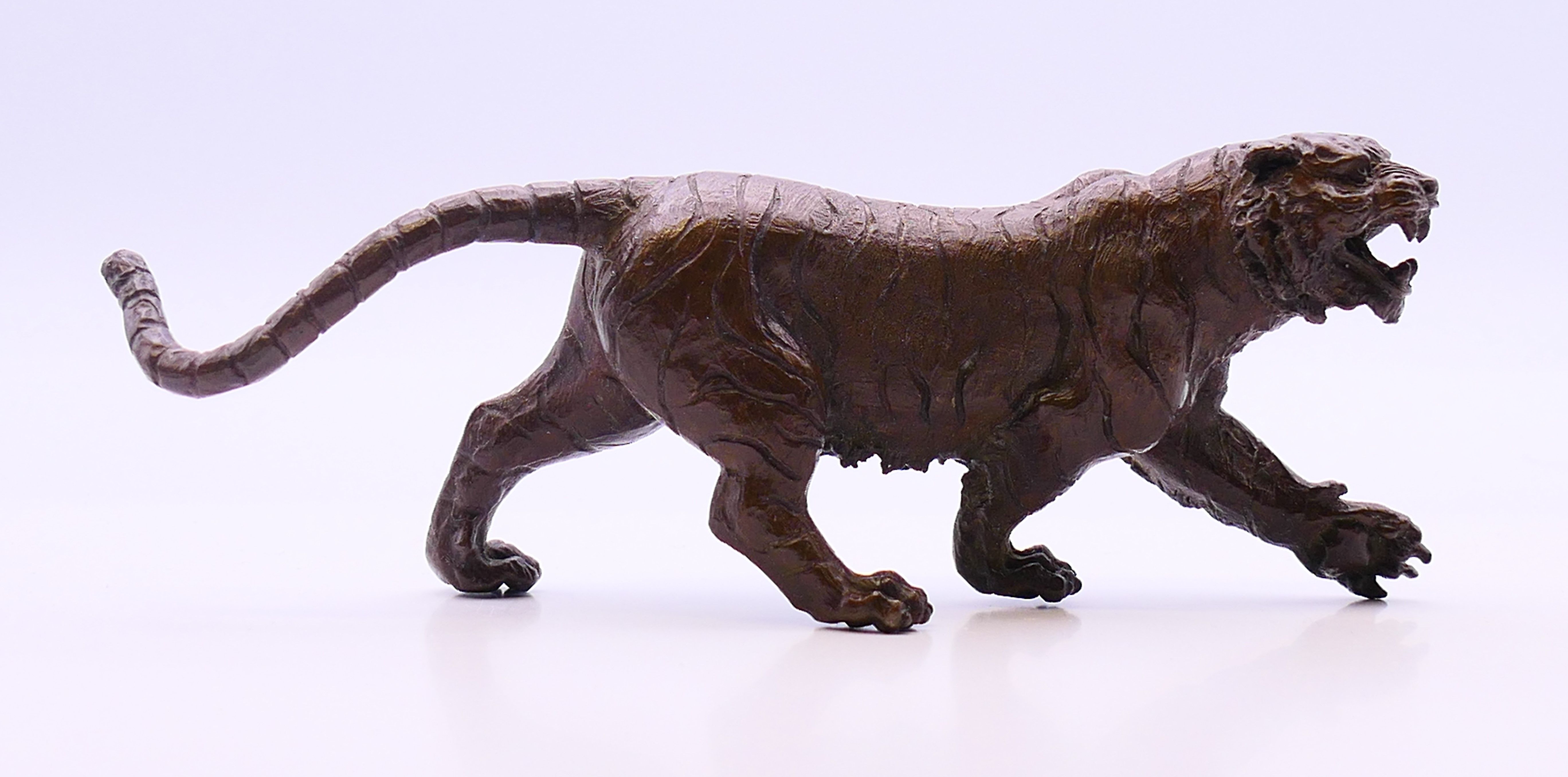 A bronze model of a tiger. 12 cm long, 5 cm high.