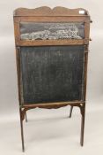 A folding blackboard with rotating teaching aid and easel. 57.5 cm wide.
