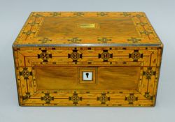 A Victorian inlaid walnut jewellery box. 29 cms wide.