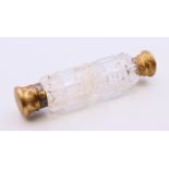 A Victorian cut glass double-ended perfume bottle with brass tops, in a leather case. 13.5 cm long.