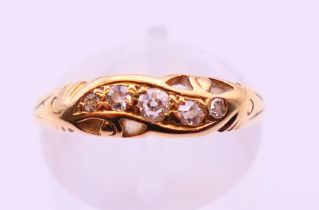 An unmarked gold and diamond ring. Ring size N.