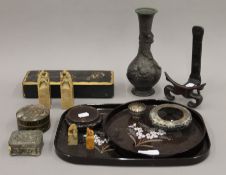 A quantity of various Eastern and Oriental items including wooden stands, seals and a bronze vase.