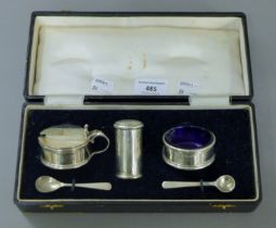 A cased silver cruet set. The case 25 cm wide. 6.2 troy ounces.