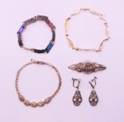 A collection of silver jewellery, to include three bracelets, a pair of earrings and a brooch.