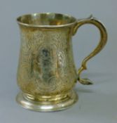 A Georgian silver tankard with embossed decoration. 12 cm high. 8.6 troy ounces.