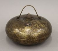 A Chinese brass foot warmer. 19 cm diameter.