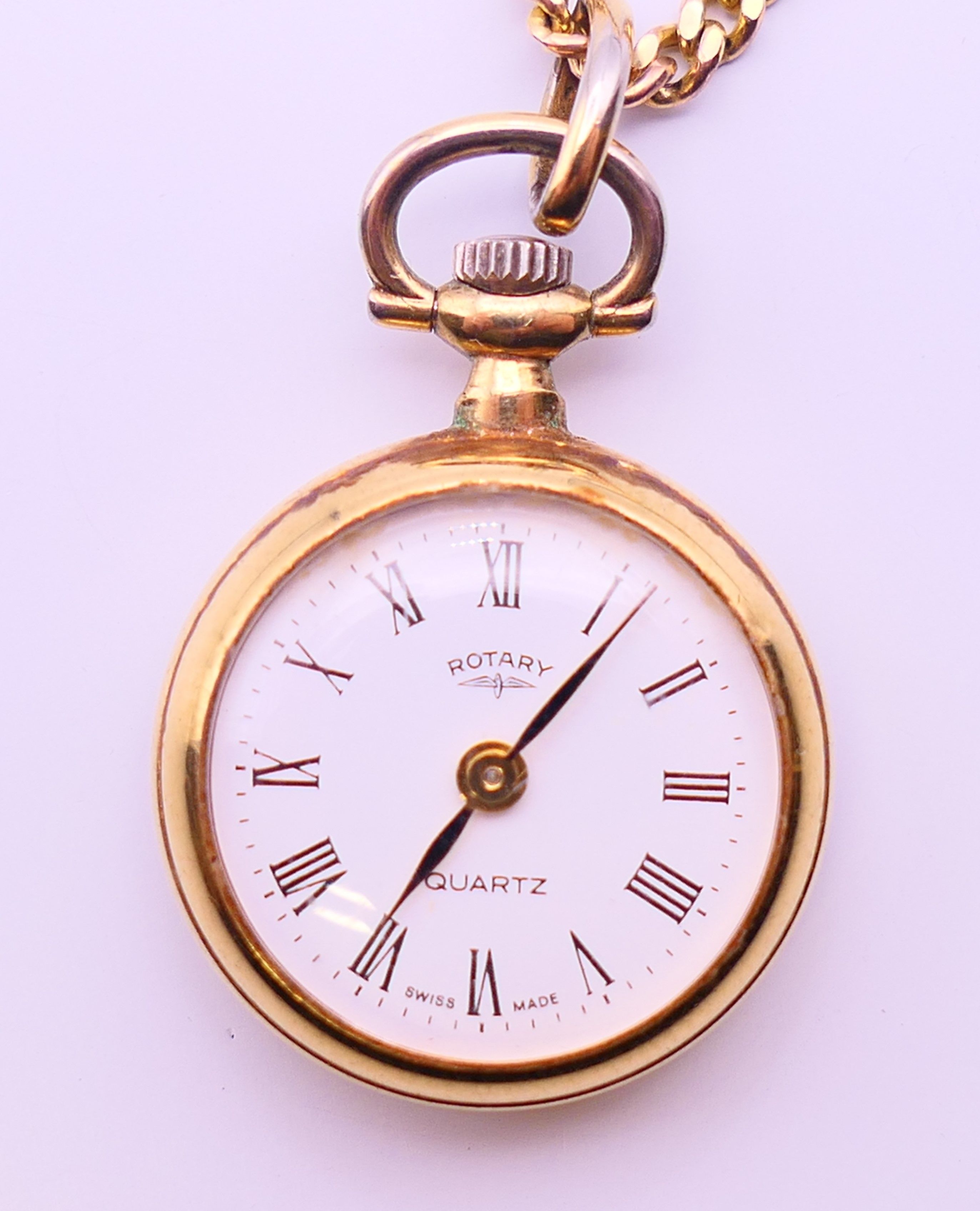 A Rotary fob watch on a 9 ct gold chain. 2.5 cm diameter, chain 62 cm long. The chain 6 grammes. - Image 2 of 8