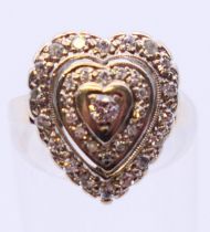 A 14 K white gold and diamond heart shaped ring. Ring size H/I.