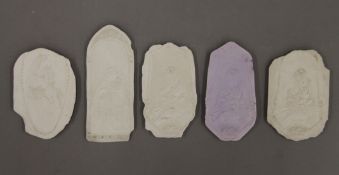 Miscellaneous plaster plaques. The largest 15.5 cm high.