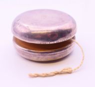 A Tiffany & Co silver clad yo-yo. 6 cm diameter.