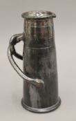 An Arts and Crafts style pottery jug with iridescent black glaze. 26 cm high.