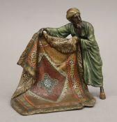 A cold-painted bronze model of an Arab carpet seller. 12 cm high.