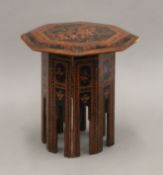 A 19th century Eastern folding tea table. 30 cm diameter.