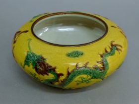 A yellow porcelain Chinese dragon bowl. 24 cm diameter.