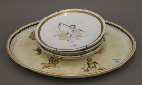 A Wedgwood platter and four Minton plates. The former 44 cm long.