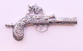 A silver miniature pistol form pendant. 6.5 cm long.