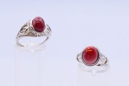Two silver and coral expandable rings.