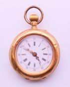 A 14 ct gold ladies fob watch. 3 cm diameter. 19.4 grammes total weight.