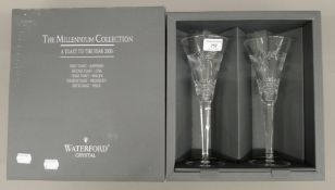 A pair of Waterford champagne glasses in the original box. 23 cm high.