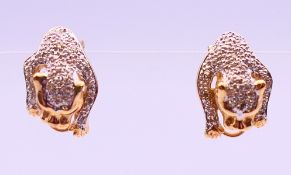 A pair of 14 K gold, diamond panther earrings. 1.75 cm high. 5.6 grammes total weight.