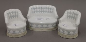 A Lladro porcelain three-piece suite. The largest 16 cm wide.