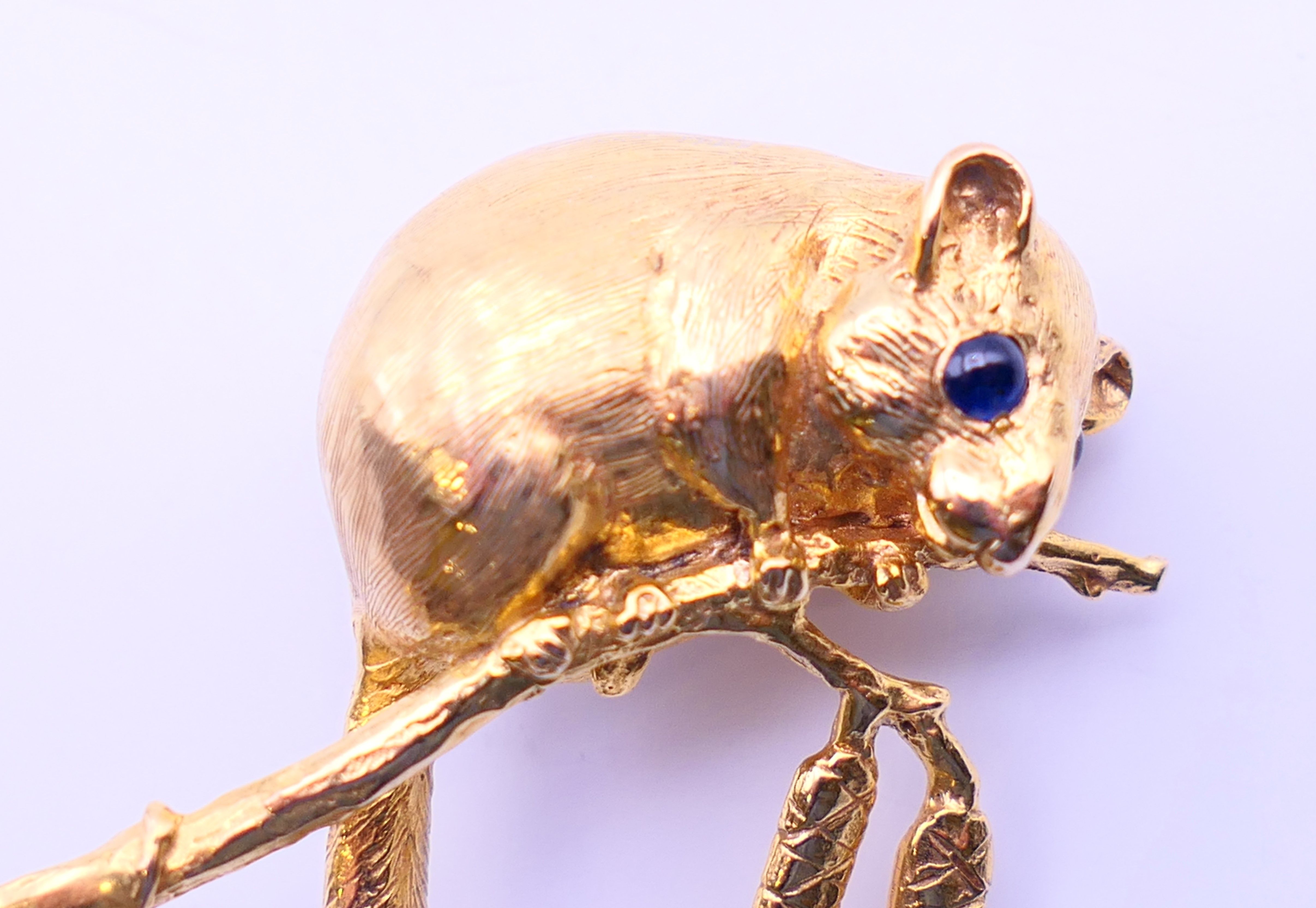 A gold dormouse form brooch with sapphire set eyes. 4 cm high. 13.9 grammes. - Image 2 of 5