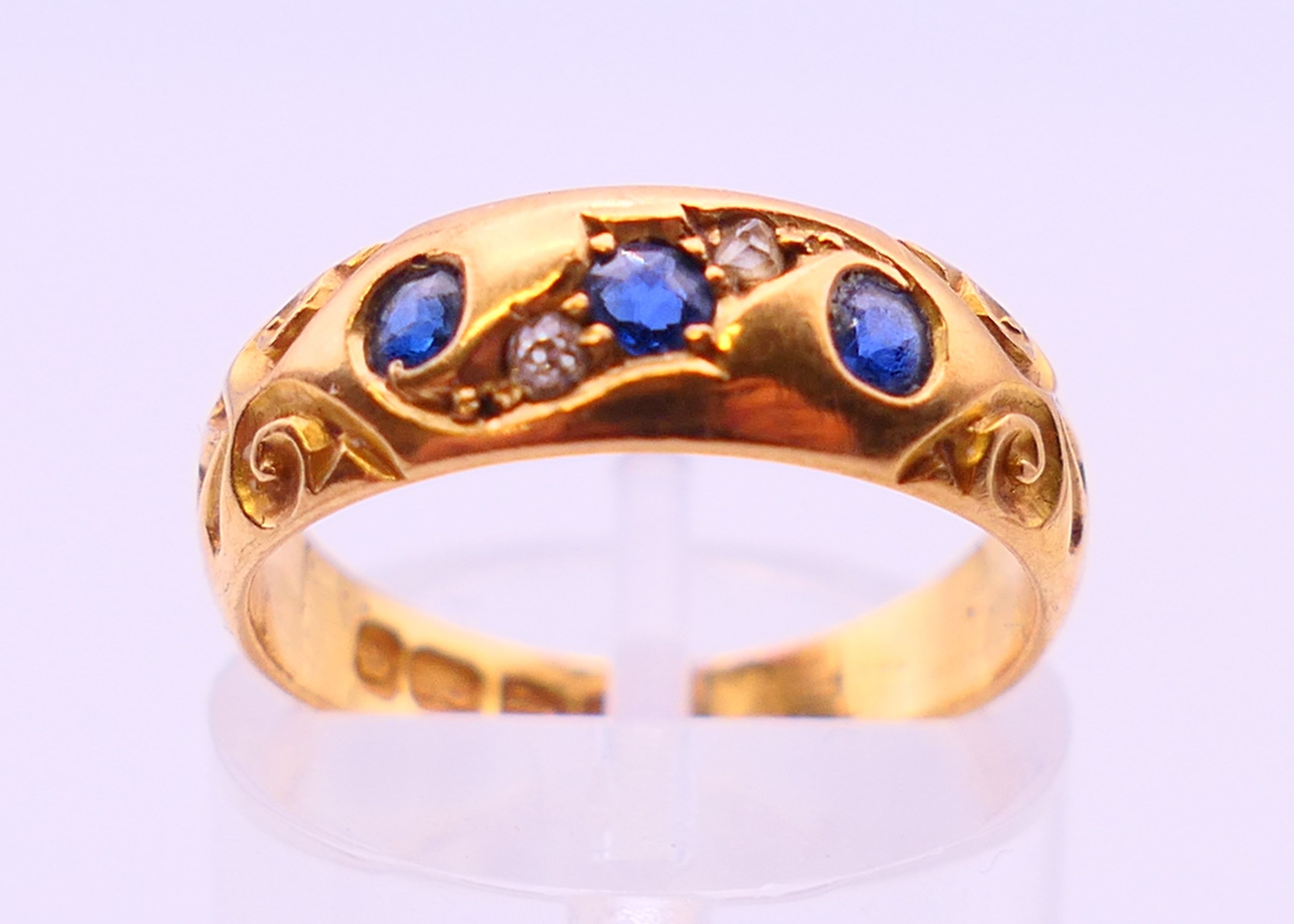 An 18 ct gold diamond and sapphire ring. 4 grammes. Ring size L/M.