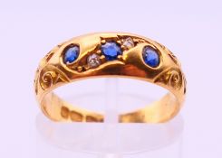 An 18 ct gold diamond and sapphire ring. 4 grammes. Ring size L/M.