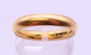 An 18 ct gold wedding band. 6 grammes. Ring size K/L.