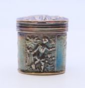 A Dutch silver pill box embossed with figures. 3.5 cm high. 25.6 grammes.