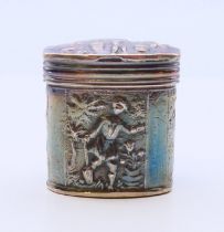 A Dutch silver pill box embossed with figures. 3.5 cm high. 25.6 grammes.