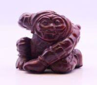 A netsuke formed as a kneeling man. 4 cm high.